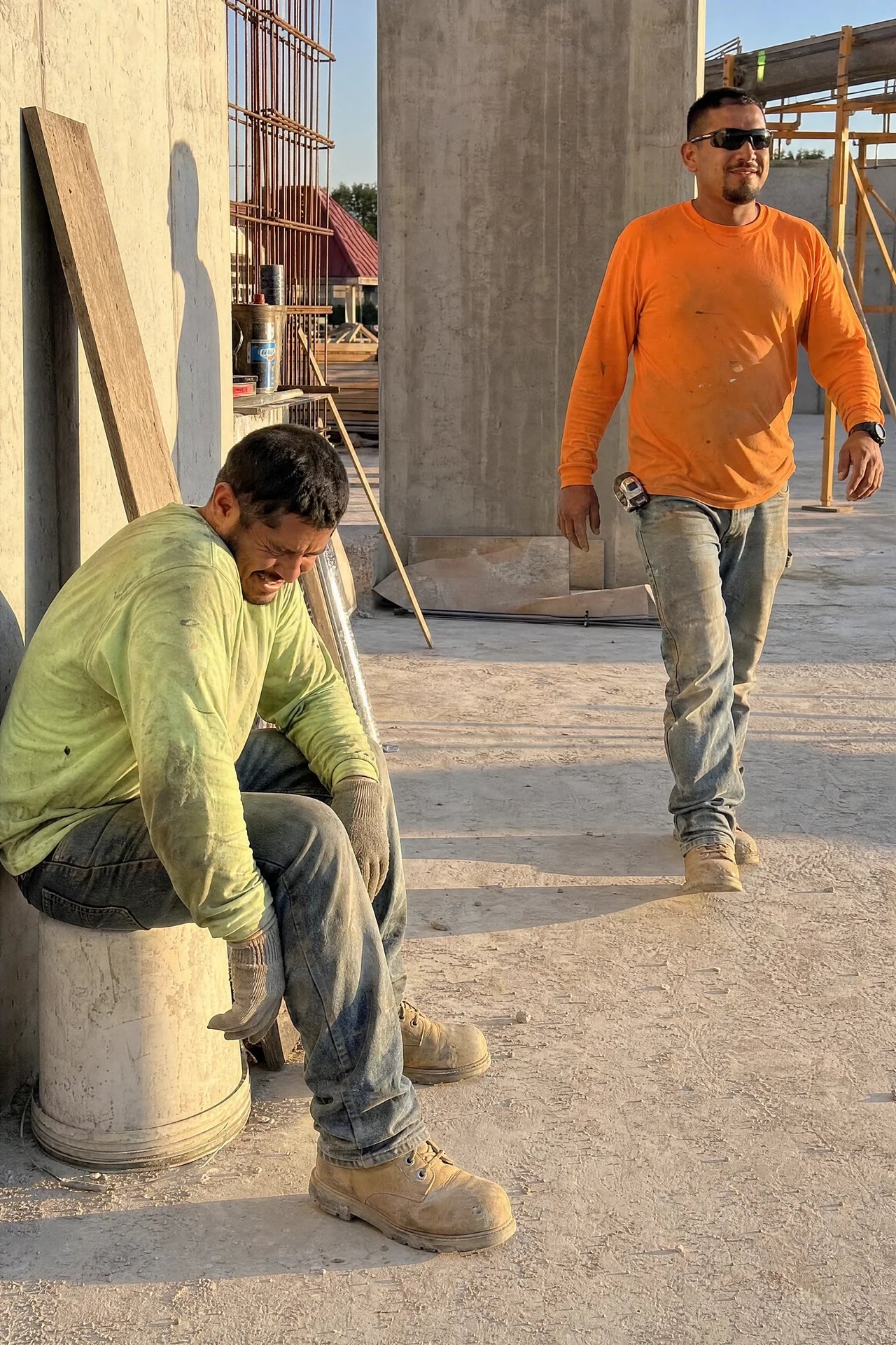 Two tradesmen after a shift — one worn out, one still going strong